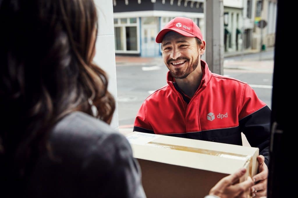 DPD Delivery Driver handing over package to resident